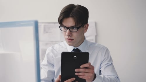 Thoughtful Man Working Deligently with Pc in Office