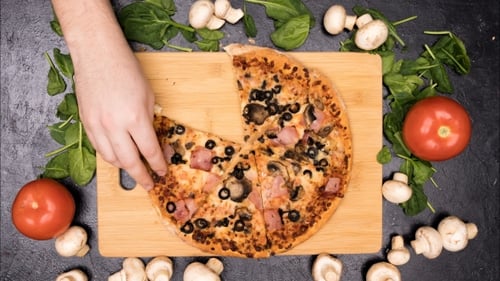 Hand Taking Pizza Slices