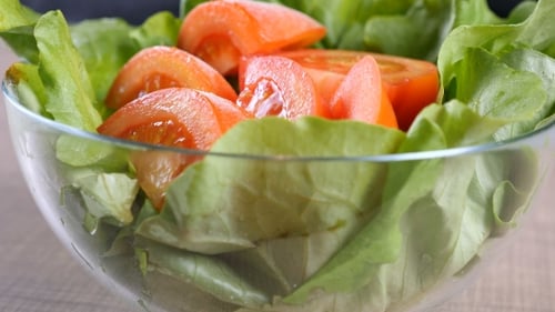 Bowl of Salad Leafs with Sliced Tomatoes