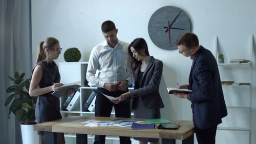 Business Team Analyzing the Graphs in the Office