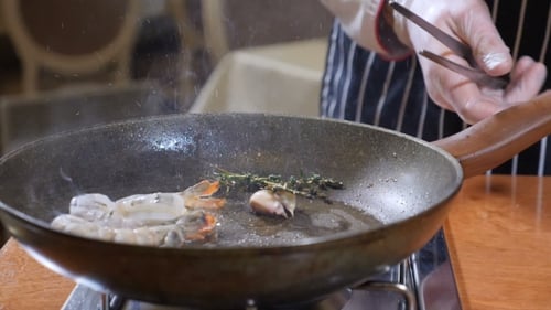 Professional Chef Cooking Shrimp in Restaurant Kitchen