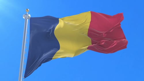 Waving Romania Flag Against Clear Blue Sky