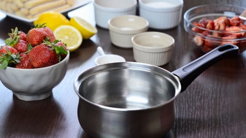 Putting Fresh Strawberries in a Saucepan
