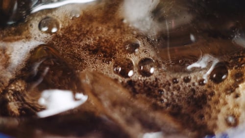 Close up of Brown Drink with Ice Cubes