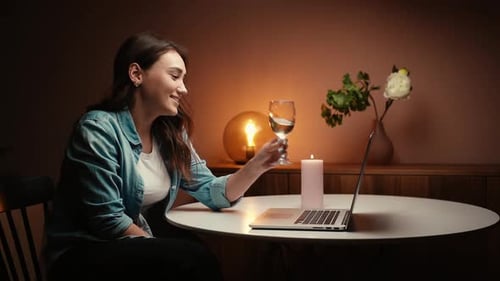 Woman Enjoys Video Call with Glass of Wine