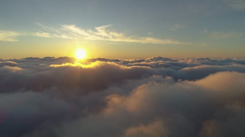 Flying over Pink Clouds at Colorful Sunrise. Aerial View