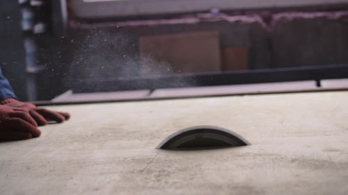 Carpenter Cuts Wood with Table Saw in Workshop