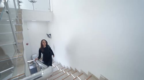 Woman Walking Up Stairs