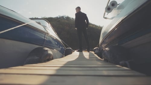 Young Businessman Goes Past the Front Light Boat