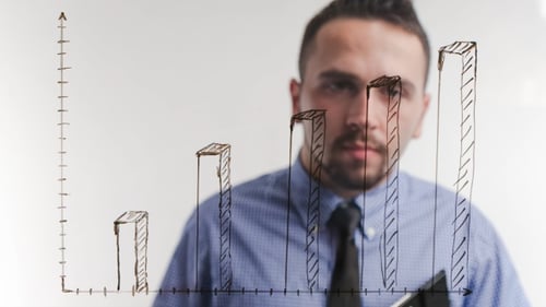 Adult Drawing Bar Graph on Clear Board