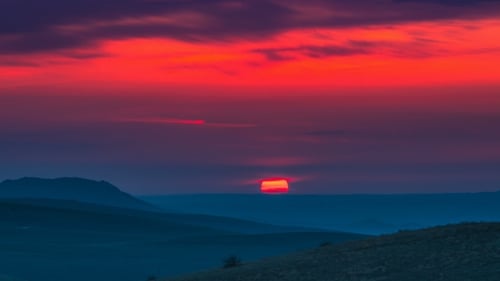 Red Sunset in the Mountains Landscape with Cloudy Sky
