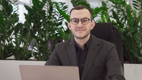 Man Works on Laptop in Modern Office