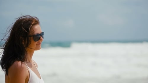 Portrait of a Young Woman in White Dress Standing on Sea Background