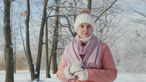 Happy Young Woman Is Walking in the Winter Forest. A Beautiful Clear Day, the Branches of Trees Are