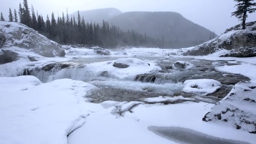 Snowy Winter River Waterfall in Snowstorm