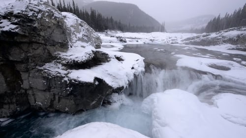 Snowy Winter River Waterfall in Snowstorm