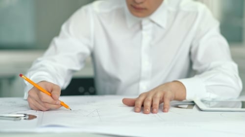 Attractive Engineer Architect Working in Office