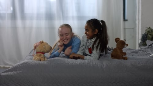 Girls Playing Together on Bed Laughing