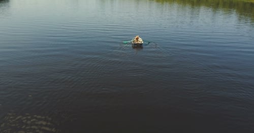 Tourist Rowing A Boat