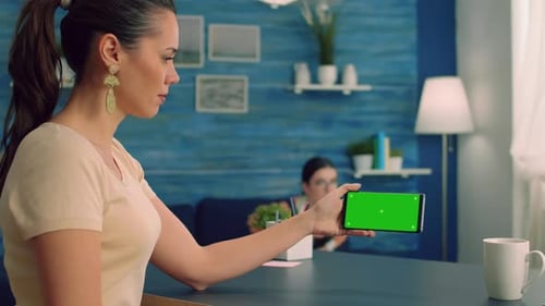 Social Media Person Holding Phone with Mock Up Green Screen