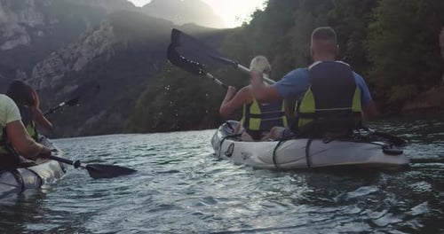 Friends Kayaking Adventure on a Mountain Lake