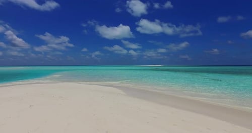 Luxury flying tourism shot of a white sand paradise beach and aqua turquoise water background in col