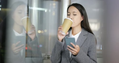 Woman Using Smartphone, Drinking Coffee at Night