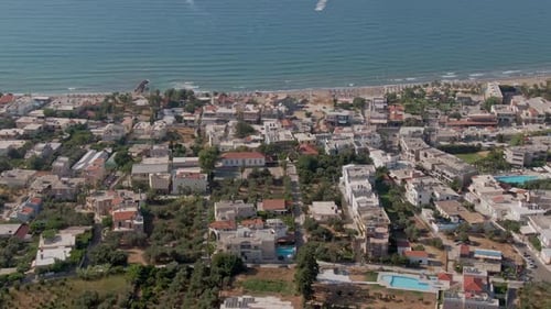Coastal Greek town of Agia Marina in Crete island, aerial drone view