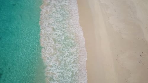 Whitecaps on Empty Sand Beach Top View