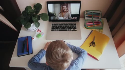 Child at Desk, Watching Online Lesson on Laptop