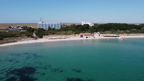Bird'seye View of the Coastline with the Blue Sea on a Summer Day People Relax and Have Fun