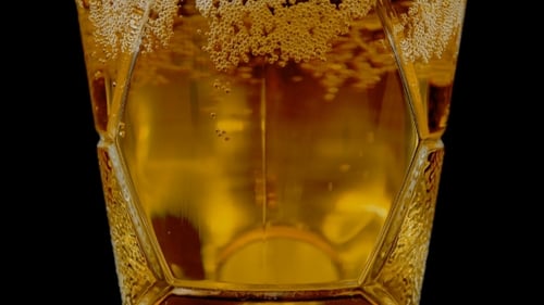 Close Up of Bubbling Beer Pouring into Glass