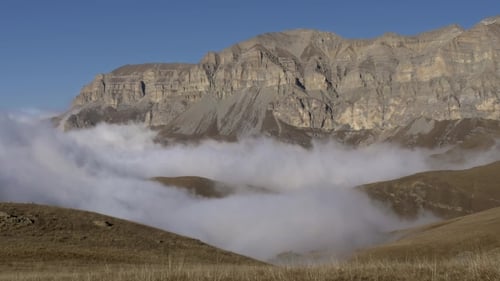 Clouds Lay Down the Valley Below the Cliff