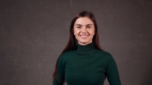 Smiling Woman with Long Brown Hair Turns to Camera