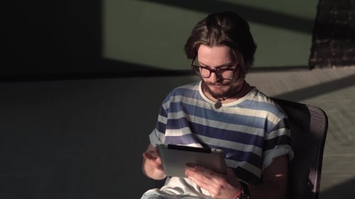 Bearded Man Uses Tablet