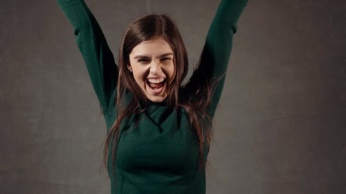 Young Woman Celebrates Success with Joyful Movements