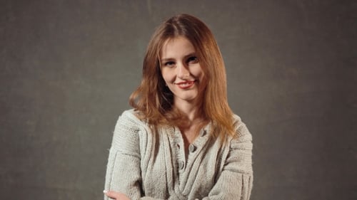 Smiling Woman in Gray Sweater Laughing Close Up