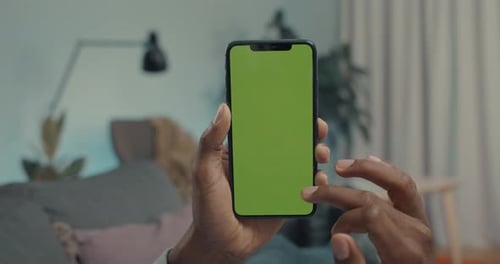Close Up of Male Hands Holding Mobile with Green Screen