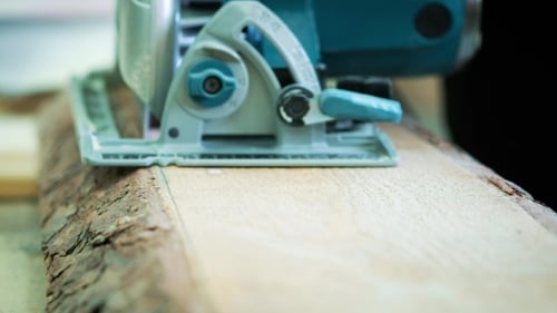 Circular Saw Cutting Wood in a Workplace