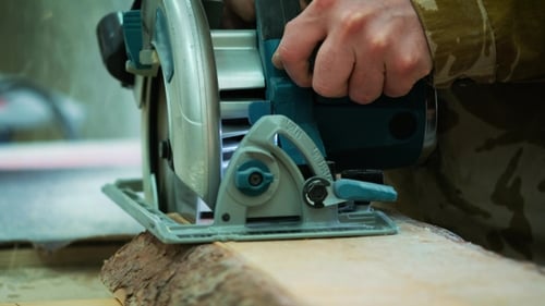 Cutting Wood with a Teal Circular Saw