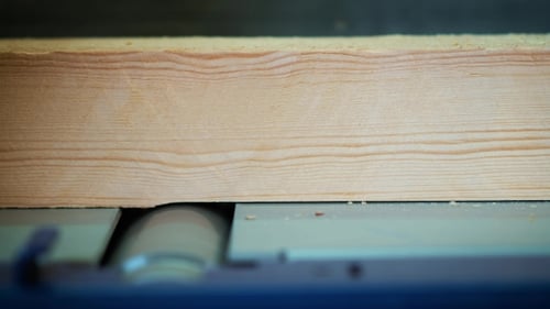 Carpenter Engaged in Woodworking. The Joiner Works with the Tree