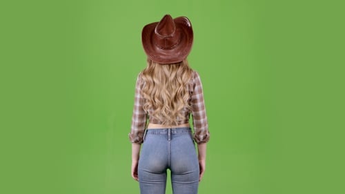 Girl Stands with Her Back Turned Around and Says Hello. Green Screen