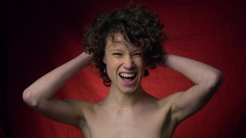 Curly Brunette Gaily Touches Her Hair