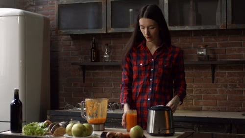 Woman Drinking Smoothie in Urban Kitchen