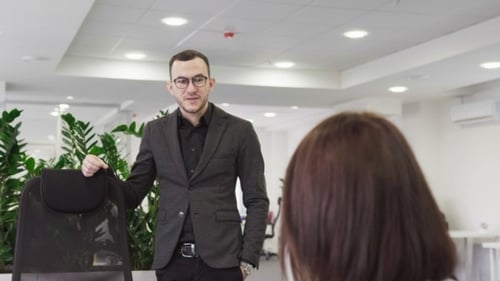 Business Man and Woman Discussing Something to Each Other in Office