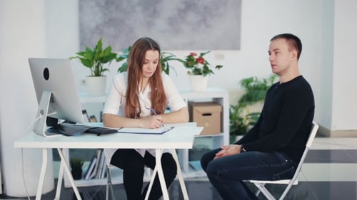 Beautiful Female Doctor Asks the Patient About the Disease