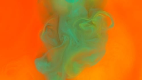 Vibrant Green and Yellow Paint Swirling on Orange