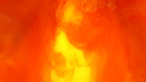 Abstract Footage of Orange and Yellow Ink Blending