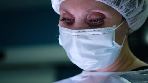 Female Surgeon's Eye. Portrait of Surgeon Woman During Surgery.