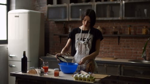 Woman Baking at Kitchen Island in Modern Home